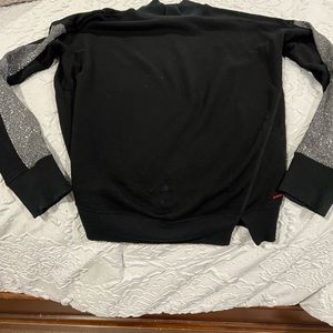 Woman’s N:Philanthropy black sweater with glitter sleeves